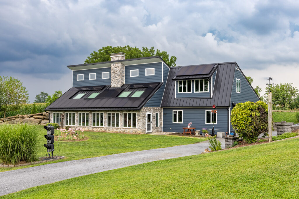 Side angle shot of the front of a house with 33 kw of Solar panels and cloudy sky in Lancaster, PA