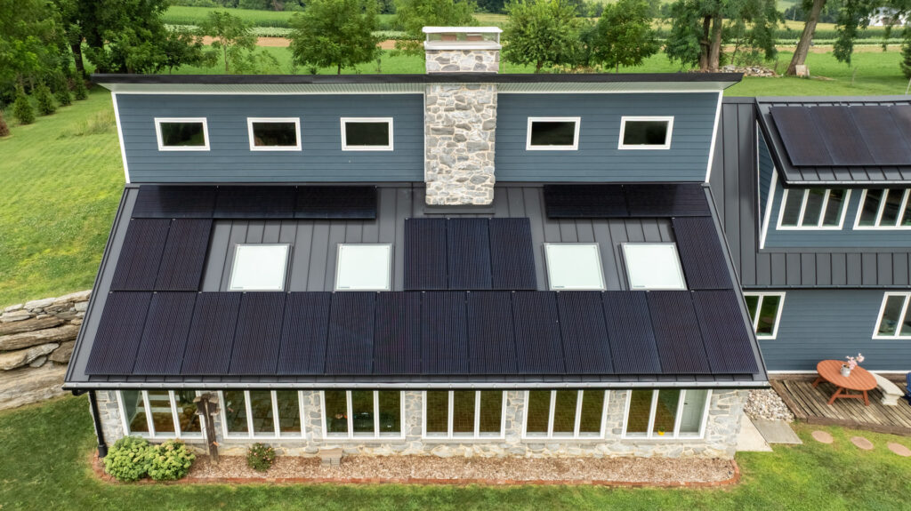 Aerial medium shot of a house with solar panels facing south in Lancaster, PA